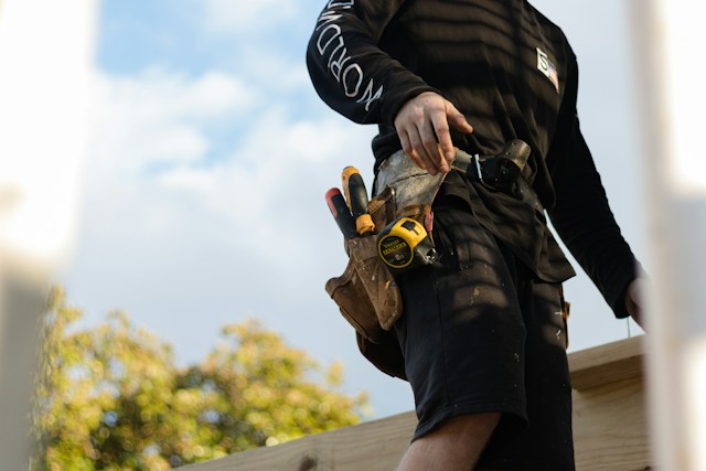 Image of a builder standing beside a deck 