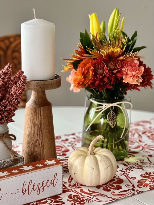 wooden candlestick and colorful flowers