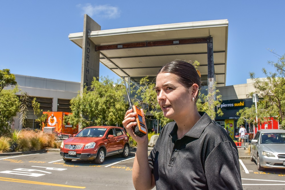 A security staffer speaks on a Tait radio.