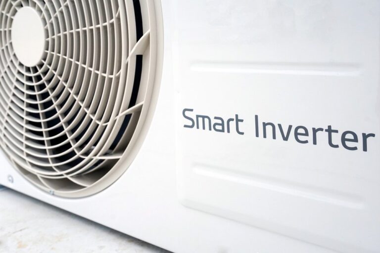A close-up of a heat pump outdoor unit with a “Smart Inverter” label, highlighting energy-efficient technology suitable for cold-climate performance.
