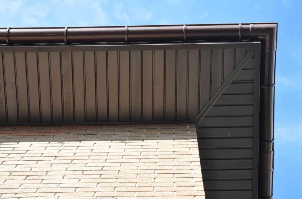 Continuous spouting installed on a modern brick home with clean fascia and soffit detailing.
