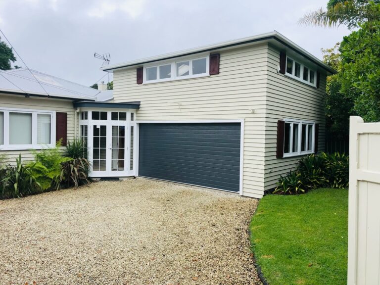 cream weatherboard house in Auckland